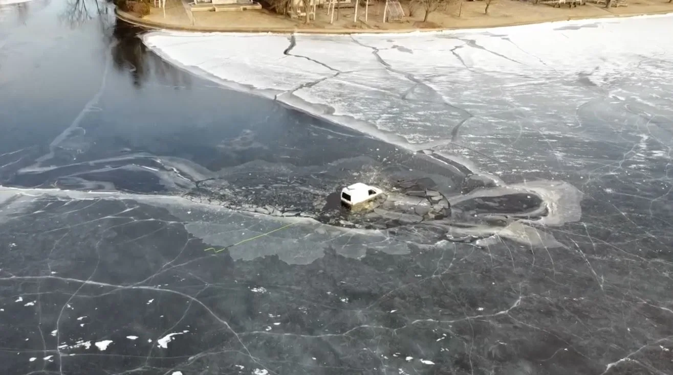 Vehicle delivering food to ice fishermen sinks through the ice